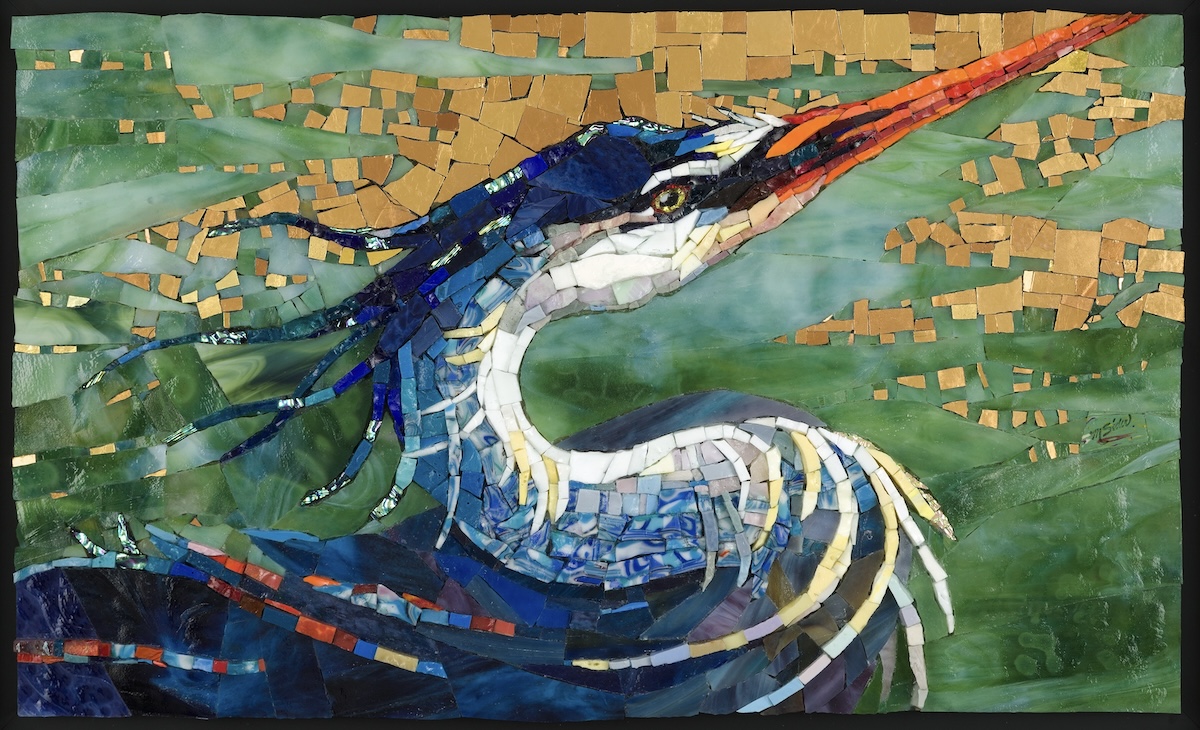 A colorful mosaic artwork of a long-beaked bird in profile, perched against swirling green water and a gold-tiled sky. The bird’s head and body are formed from layered blue, white, and yellow fragments, with an orange beak and flowing, textured feathers that create a sense of movement.
