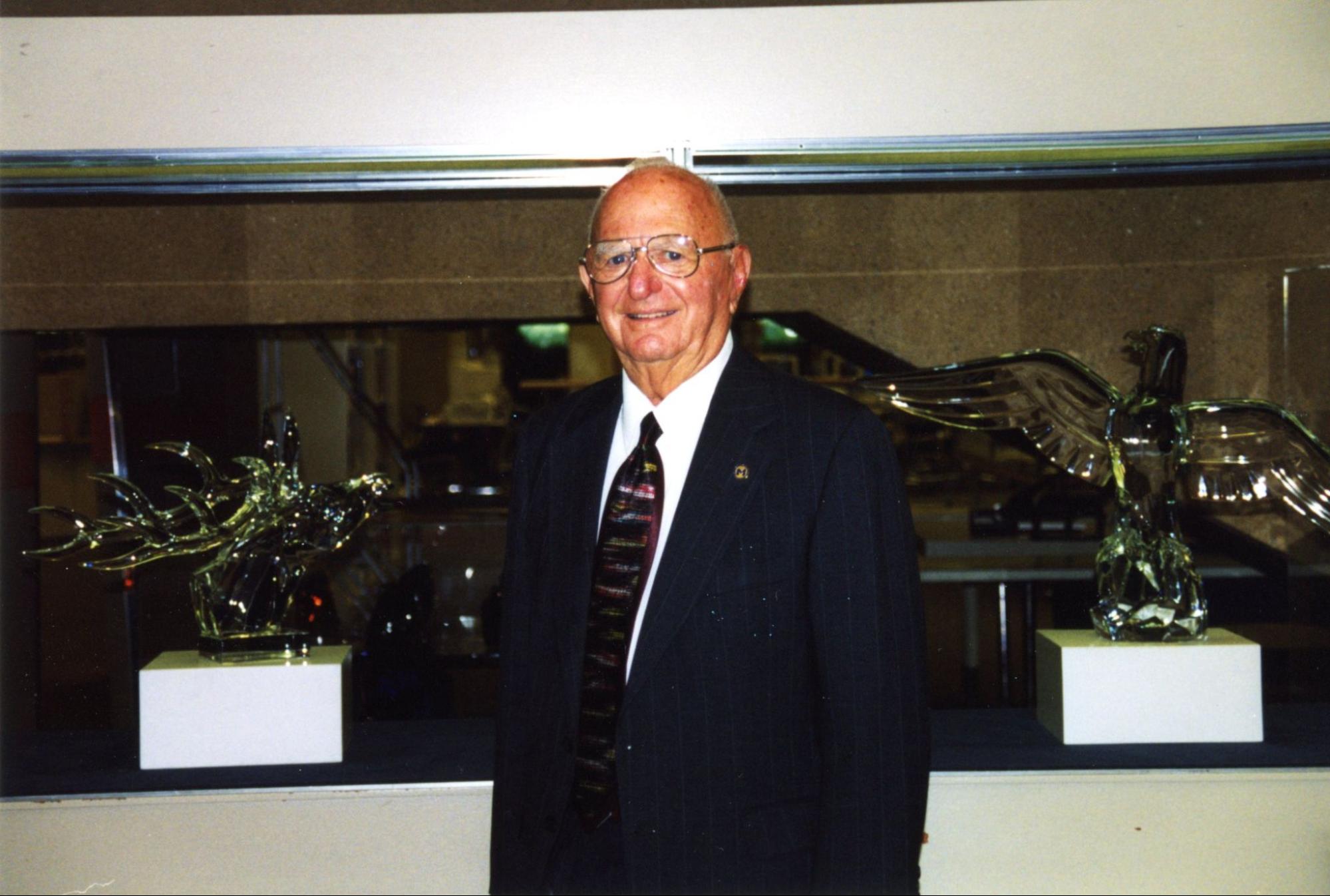 Alfred Berkowitz in front of trophies
