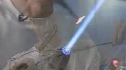 person use flame to heat a glass